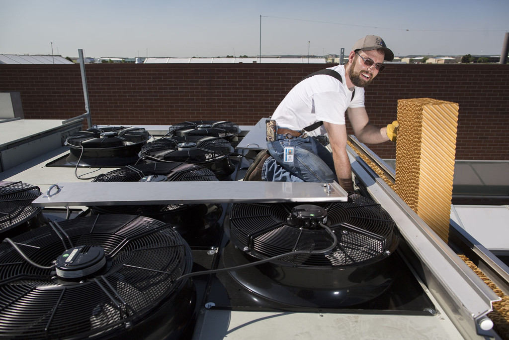 Workers install evaporative coolers on the Arapahoe County Sheriffs Office in Centennial, Colo. Thursday, June 16, 2015. (Photo by Bear Gutierrez)